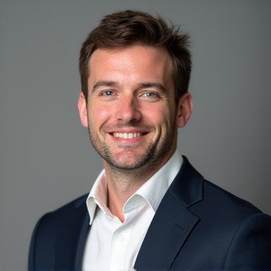 Headshot of Liam Carter, a man in his late 30s, smiling.